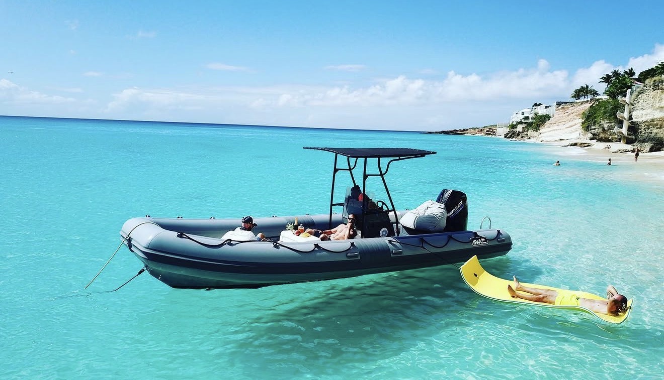 Ti Punch 6-metre RIB anchored in turquoise waters